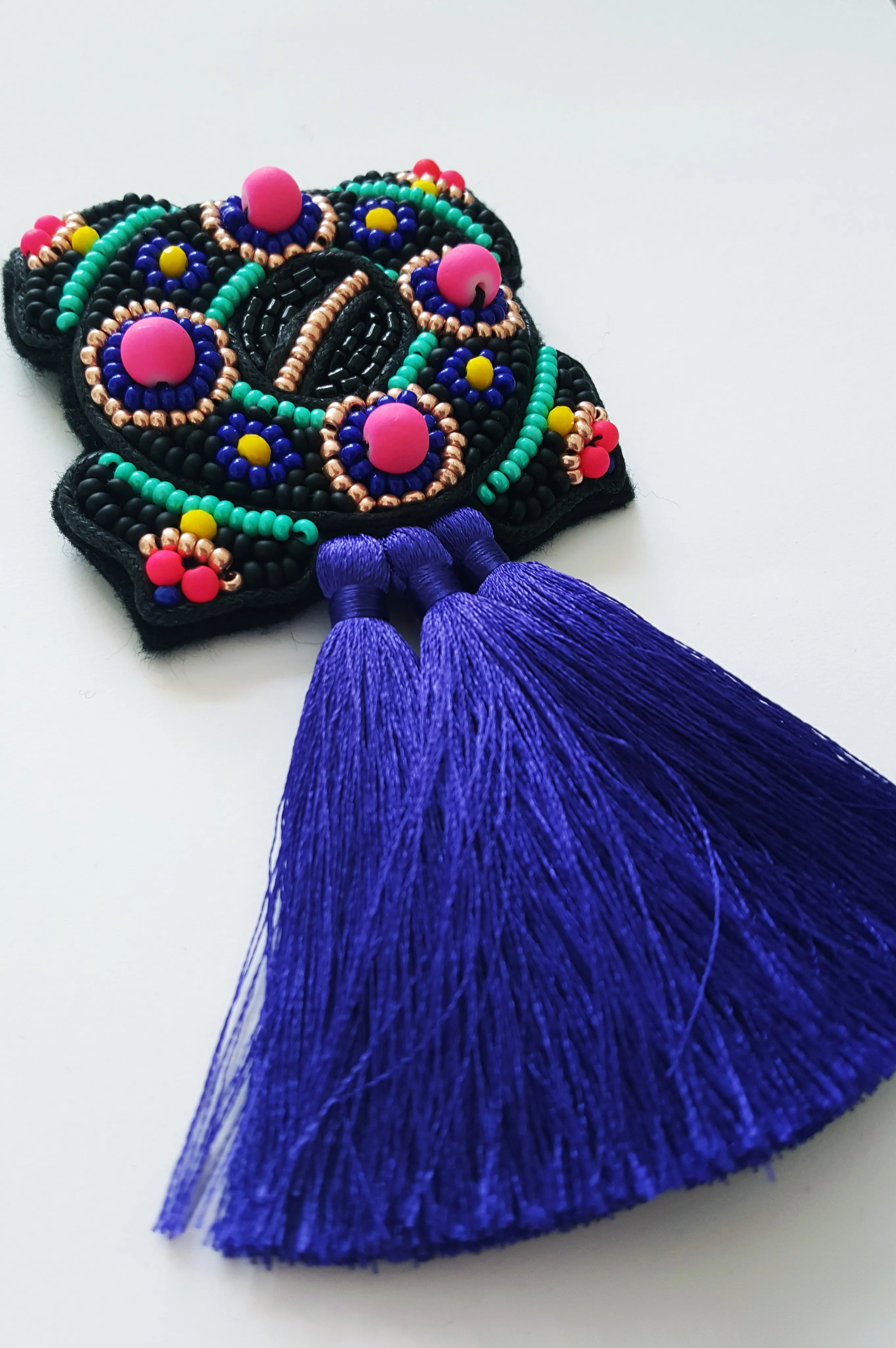 Bright and colorful Ancient brooch with tassels